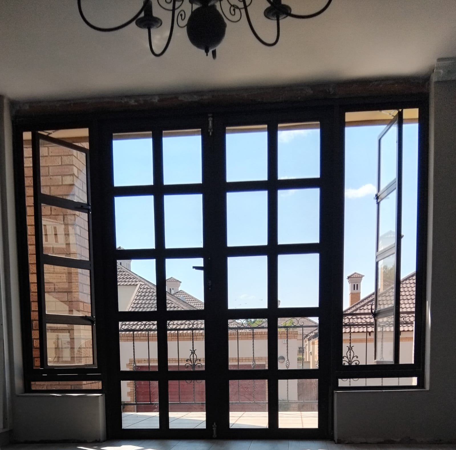 Custom hinge door with side-opening windows in Centurion