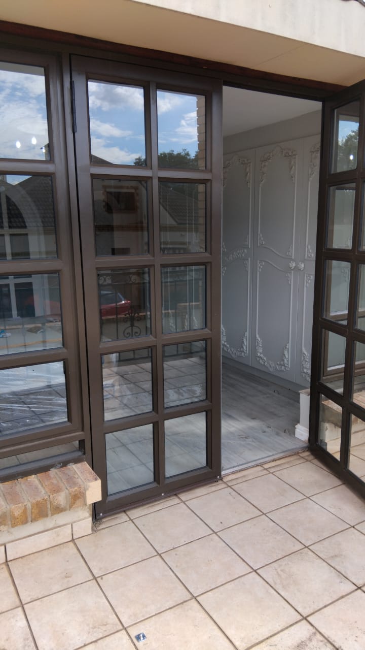 Custom hinge door with side-opening windows in Centurion